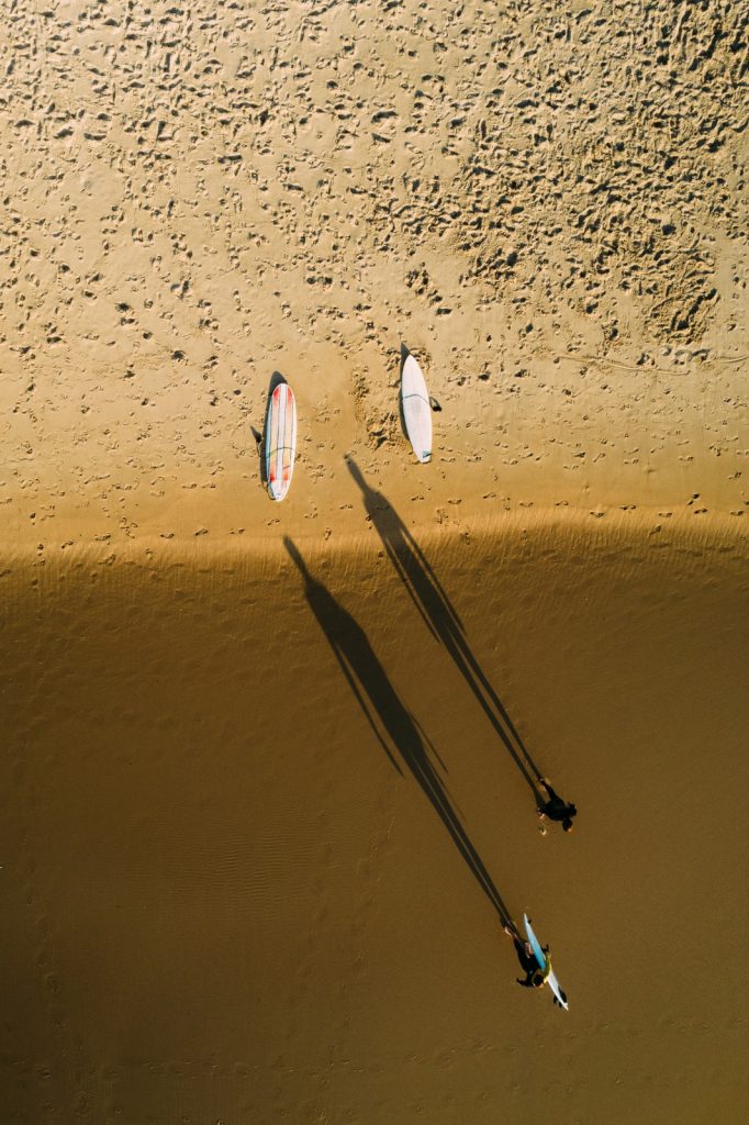 aerial photo of Portugal beach and surfers by Alexandre Rotenberg